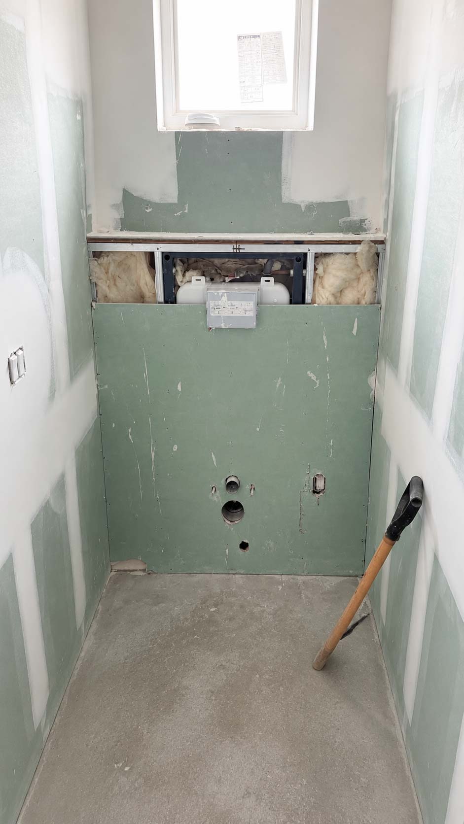 New shower wall prepared with plumbing connections for fixture installation